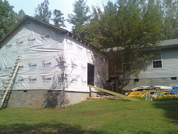 Tyvek wrapped gable on a new room addition beside an existing home in North Dighton