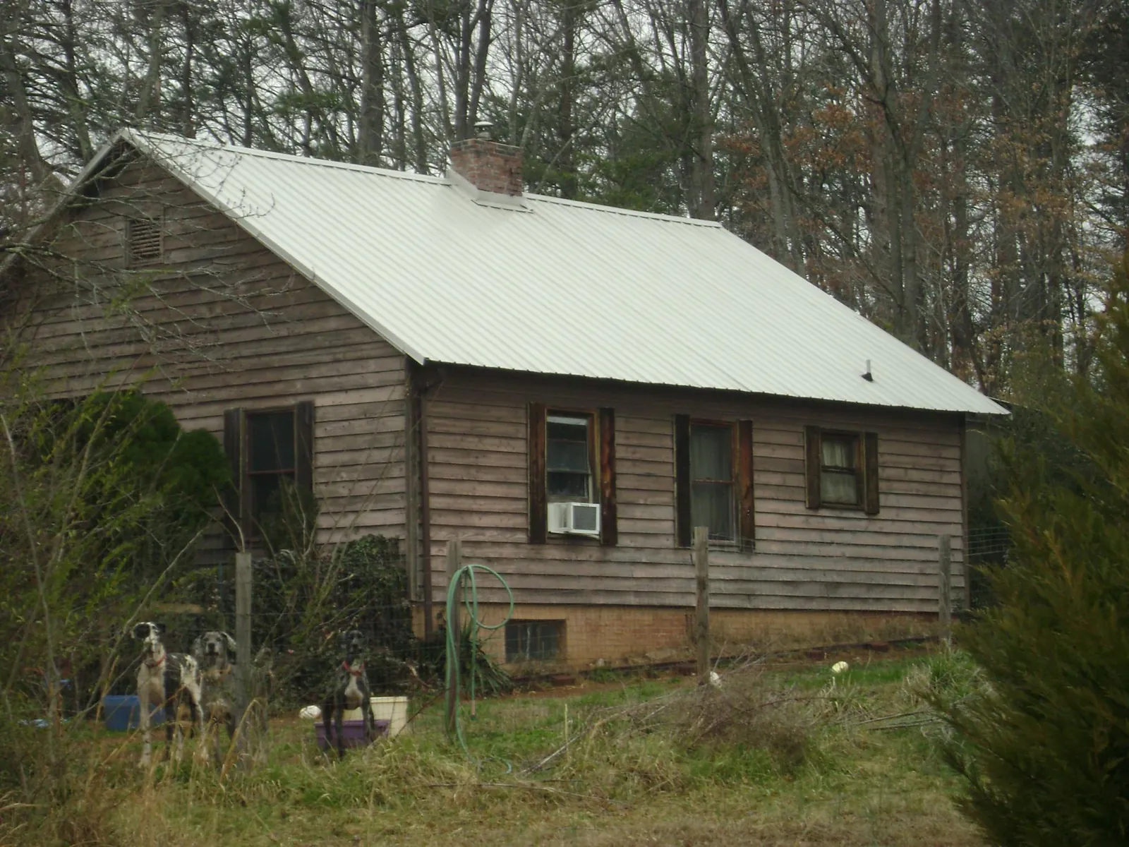 White metal roof on an old wood sided farmhouse, from a Metal Roof Installation job in North Dighton